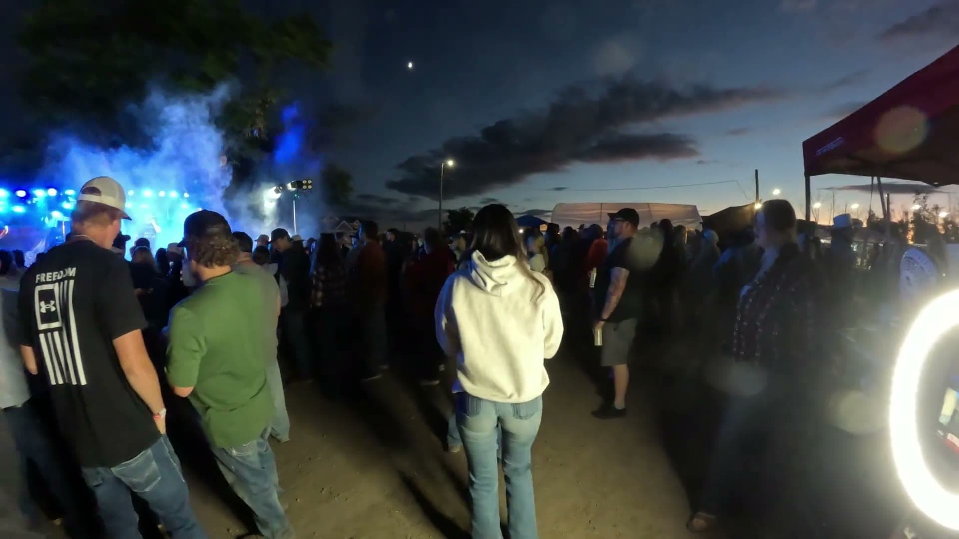 Crowd gathered in front of the stage at dusk during a Rhyme Or Reason show